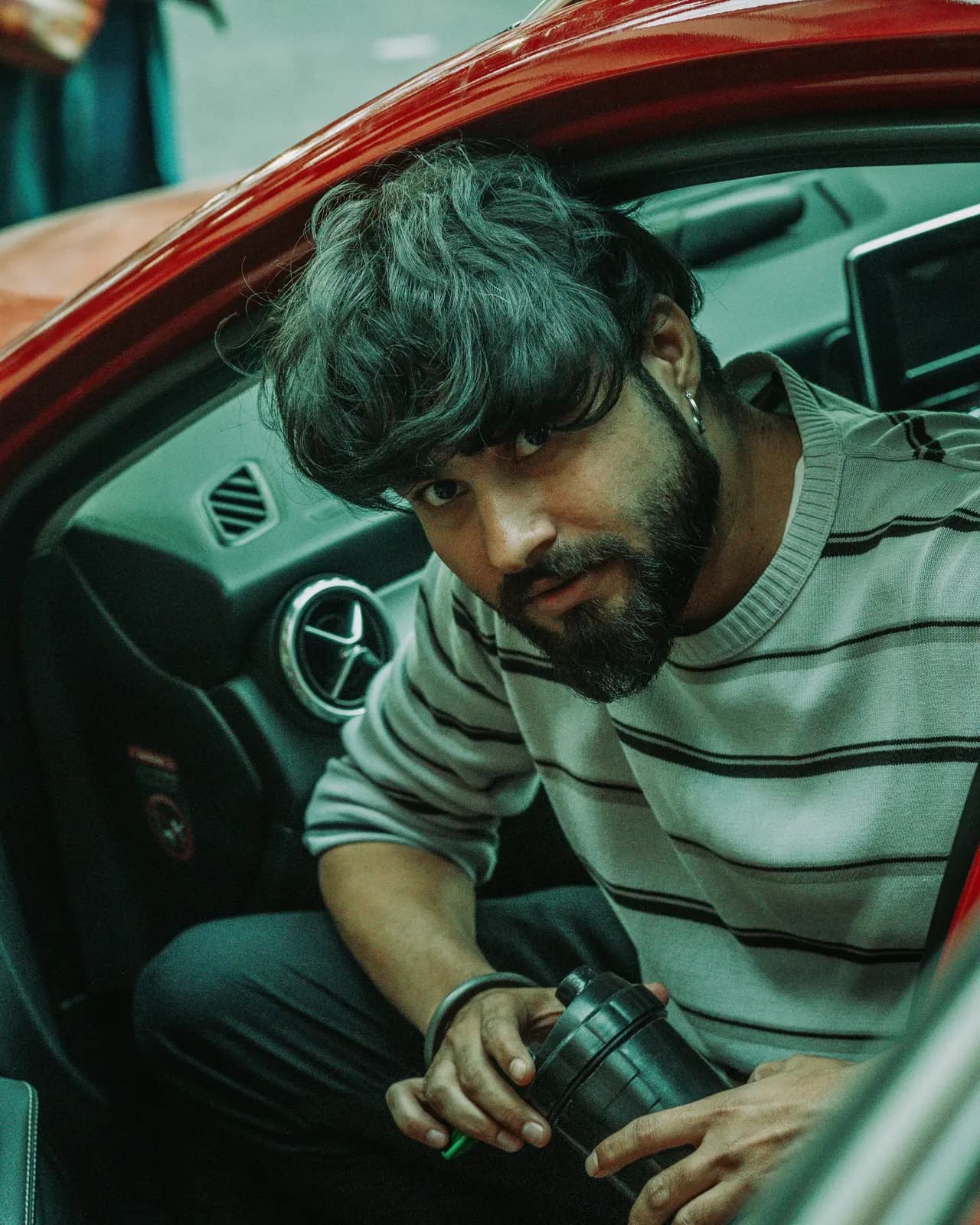 A young man sitting in a car